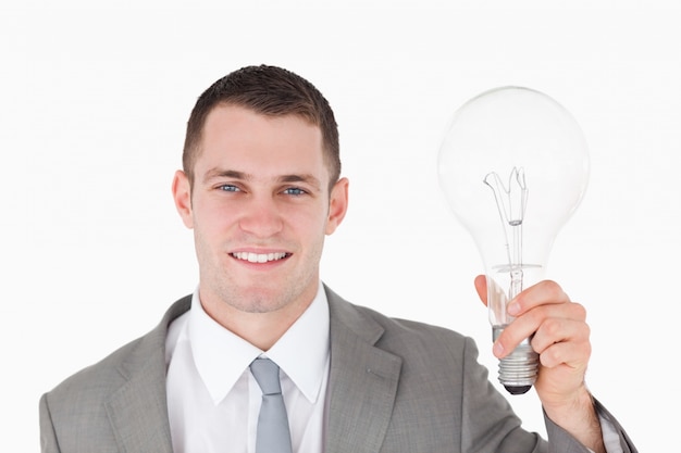 Businessman holding a bulb