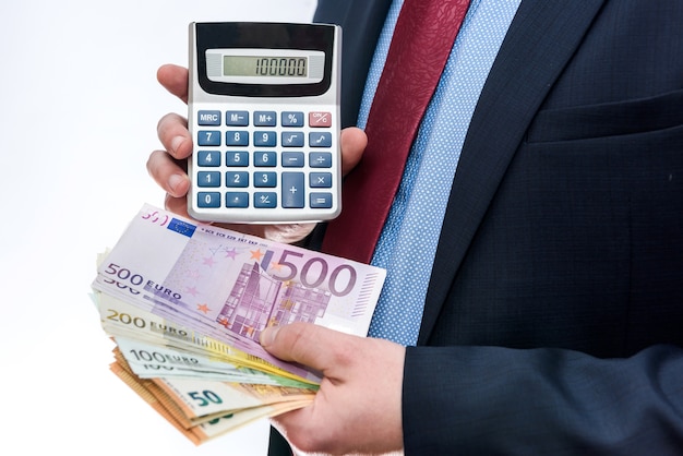 Businessman holding calculator and euro banknotes closeup