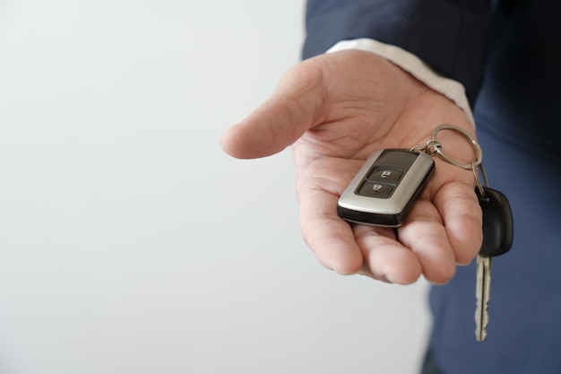 Businessman holding car key concept of buy new vehicle car