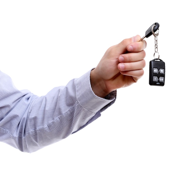 Businessman holding car key isolated on white