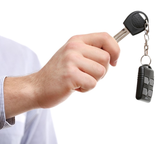 Businessman holding car key isolated on white