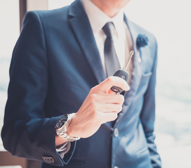 Businessman holding a car key