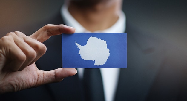 Businessman Holding Card of Antarctica Flag