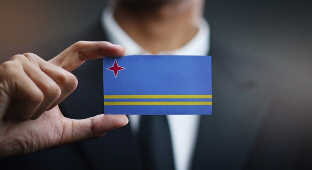 Businessman Holding Card of Aruba Flag 