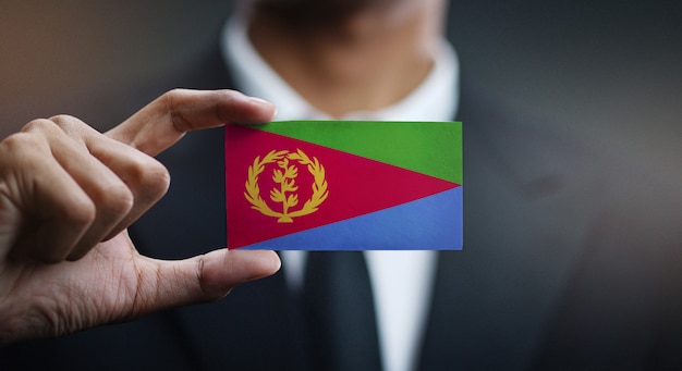 Businessman Holding Card of Eritrea Flag 