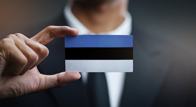 Businessman Holding Card of Estonia Flag