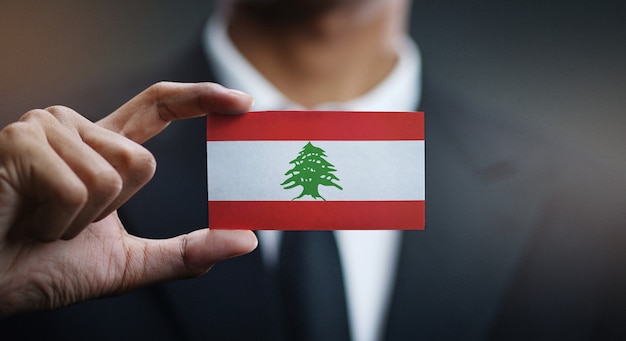 Businessman Holding Card of Lebanon Flag 