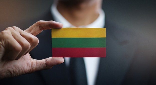 Businessman Holding Card of Lithuania Flag 