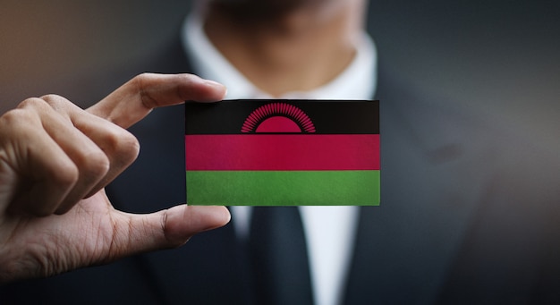 Businessman Holding Card of Malawi Flag 