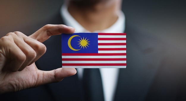 Businessman Holding Card of Malaysia Flag 