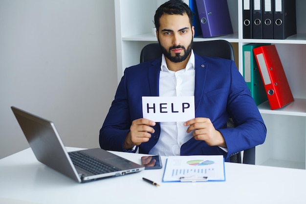 Businessman holding a card with text Help