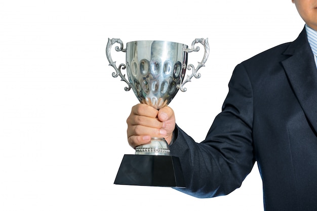 Businessman holding a champion silver trophy on white background
