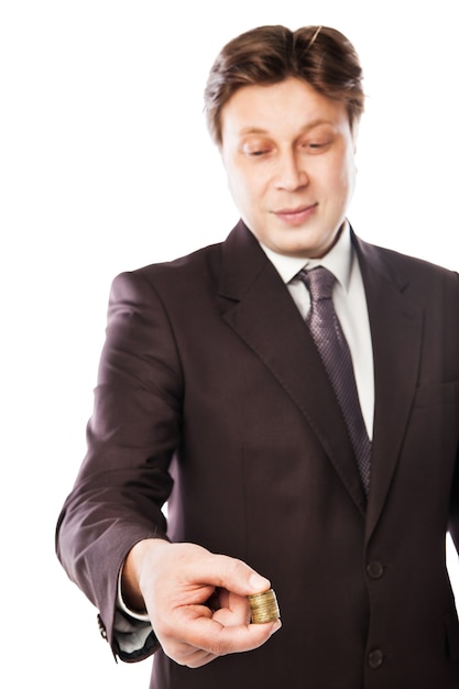 Businessman holding coins in his hand isolated over white