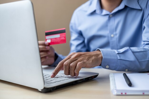 Businessman holding credit card  for online shopping 