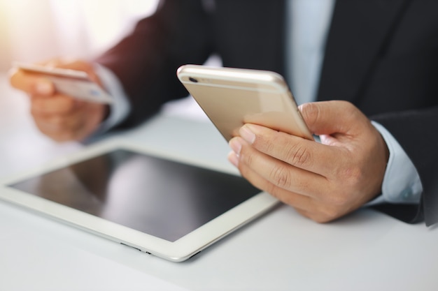 Businessman holding credit card and smartphone