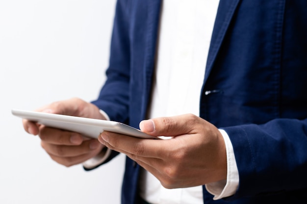 Businessman holding digital tablet device in hands.