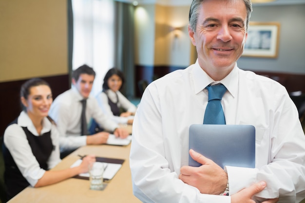 Businessman holding digital tablet at meeting