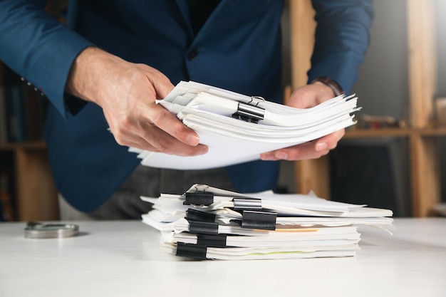 Businessman holding documents in office closeupxdxa