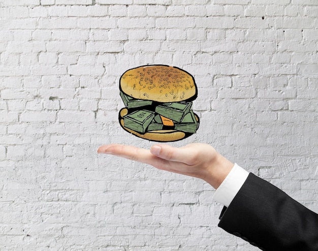 Foto uomo d'affari che tiene hamburger del dollaro