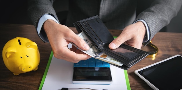 Businessman holding dollars with wallet