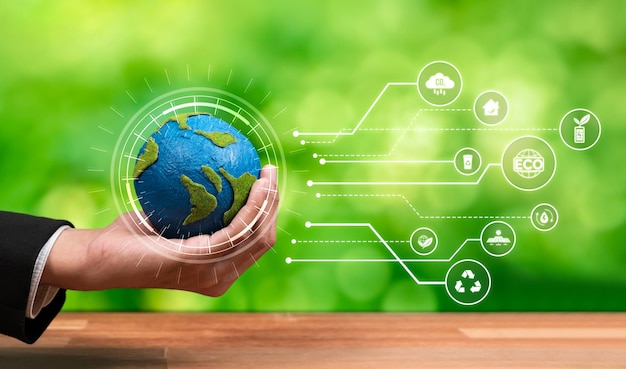 Businessman holding Earth with eco friendly icon design symbolize business company commitment to protect planet Earth's ecosystem with net zero technology and ESG practice Reliance