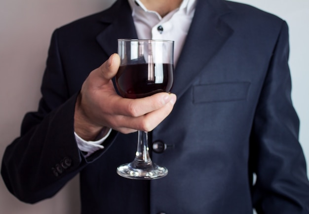 Бизнесмен, держащий бокал вина