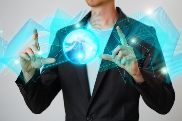 Businessman holding the glowing hologram digital globe Concepr of business and innovation