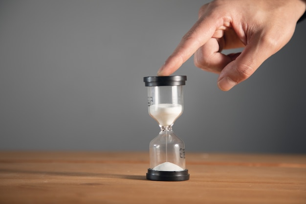 Businessman holding hourglass in the office.