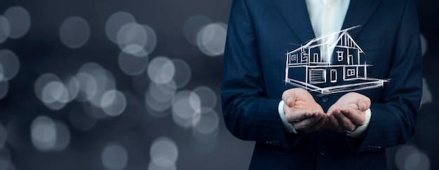 Businessman holding a house icon