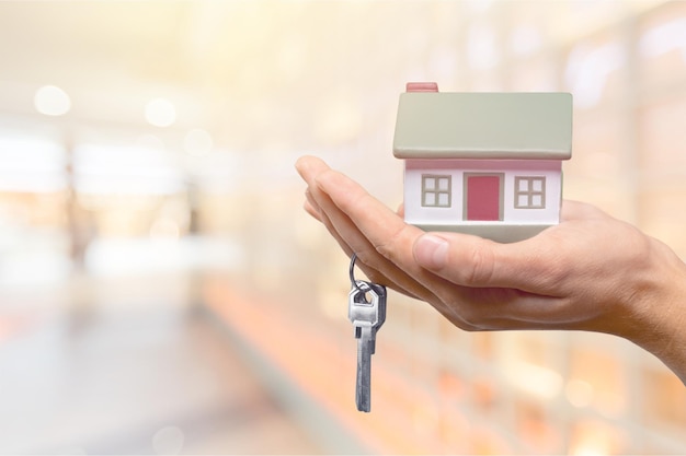 Businessman Holding House Model and Keys, Real Estate Concept