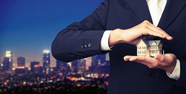 Businessman Holding House Model