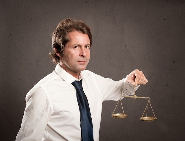 Businessman holding a justice scale