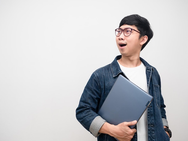 Businessman holding laptop excited emotion looking at copy space