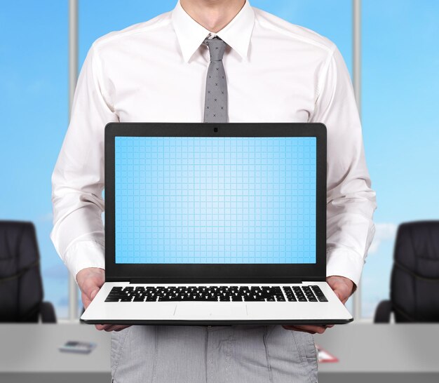 Businessman holding laptop