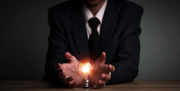 Photo businessman holding a light bulb creative new idea innovation brainstorming solution and inspiration concepts imagination creative thinking problem solvingxd