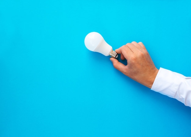 Businessman holding light bulb