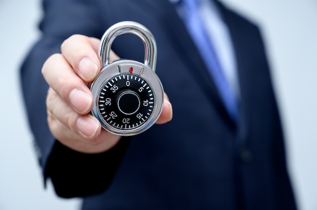 Businessman holding a lock.