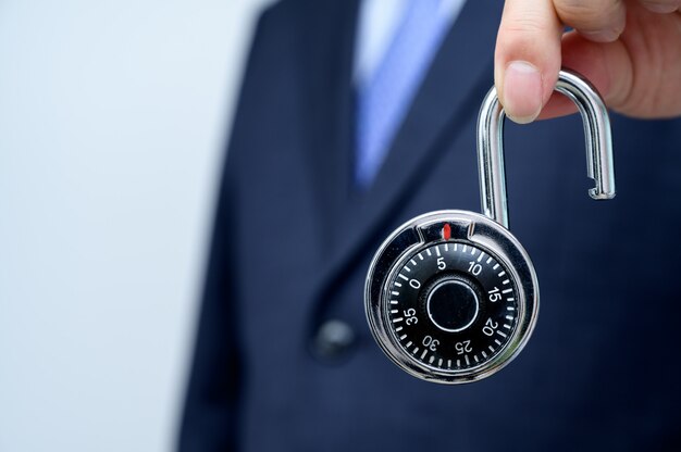 businessman holding a lock.