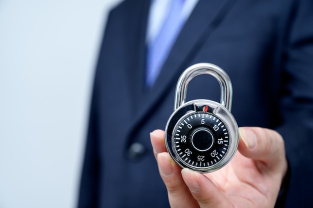 Businessman holding a lock.