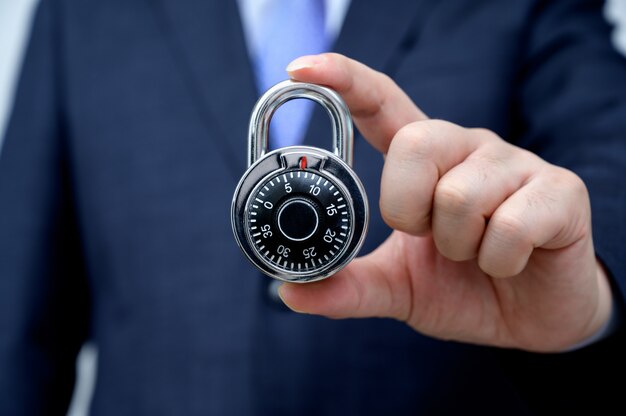 businessman holding a lock.