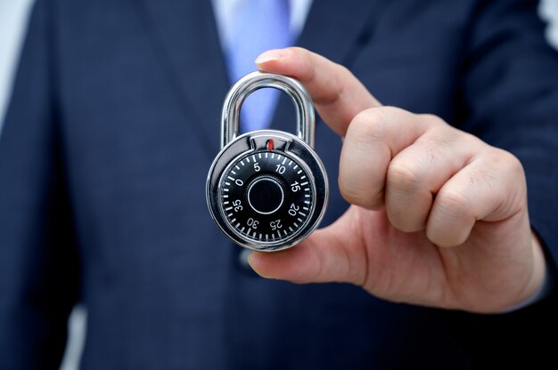 Businessman holding a lock.