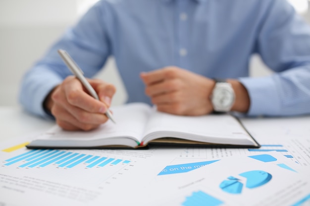 Businessman holding pan in hand financial statistics