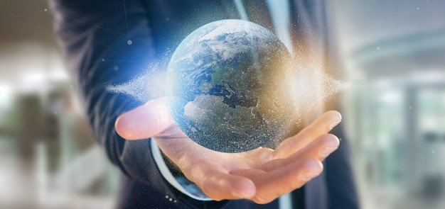 Businessman holding a  particles earth globe 