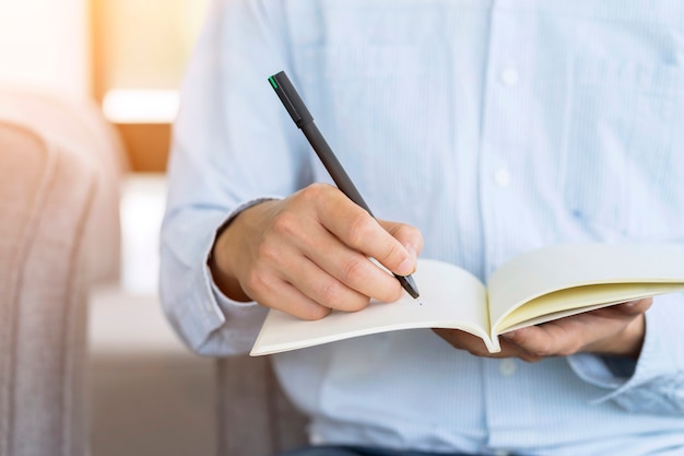 businessman holding pen and notebook, Writing something idea on note or check list