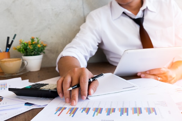 Businessman holding a pencil for working on his job