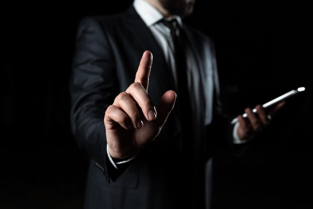 Businessman Holding Phone And Pointing With One Finger On Important Message Executive In Suit Presenting Crutial Information Gentleman Showing Critical Announcement