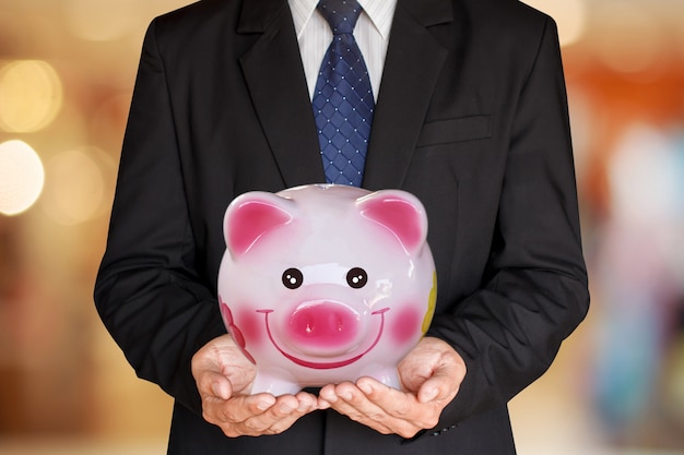 Businessman holding piggy bank  finance savings
