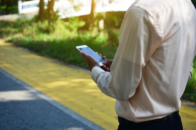 Businessman holding smart phone and using  internet online