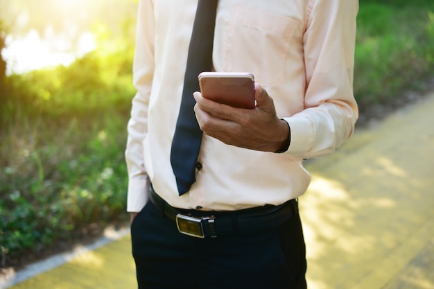 Businessman holding smart phone and using internet online