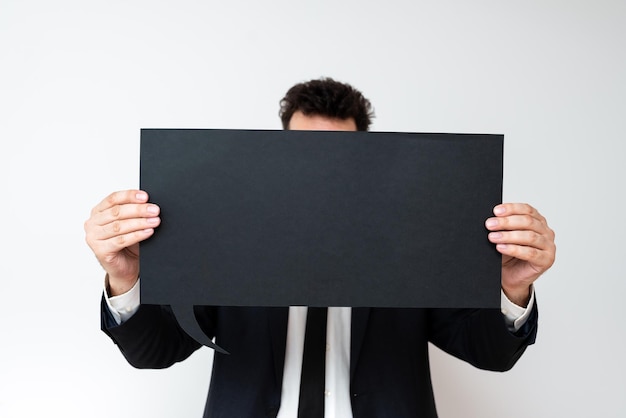 Businessman holding speech bubble with important messages man in suit presenting crutial